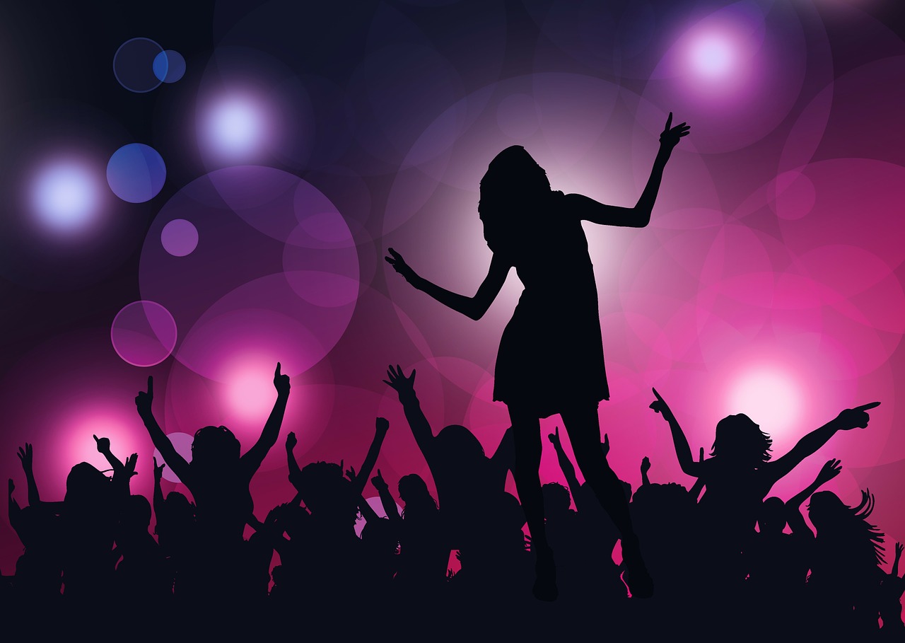 Silhouettes of people dancing under club lighting Silhouettes of people dancing under club lighting